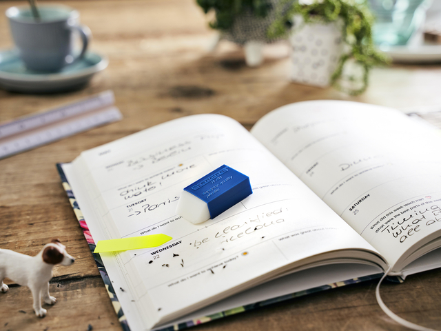 planner, open diary, blue eraser, open notebook, wooden table